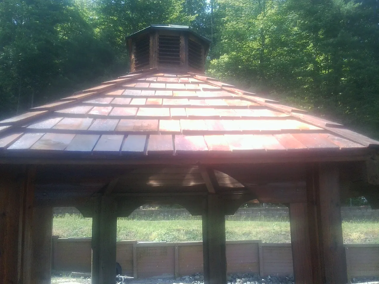 New cedar shake roof and cupola on a lakeside gazebo in Nolanville